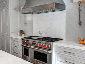 Sb-Zero stove and vent with a marble backsplash